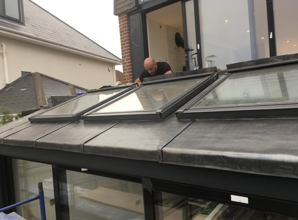 killed tradesperson performing lead roofing installation on a building, ensuring secure waterproofing